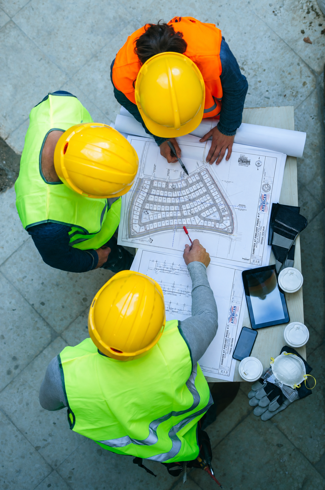 American Consulting & Engineering engineering team reviewing construction plans on site